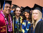 Four students dressed in Academic Regalia at Graduation Ceremonies.